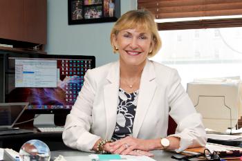 Kathleen Brady, M.D. behind desk